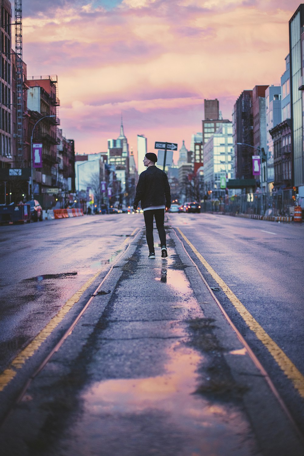 man walking at the middle of the street