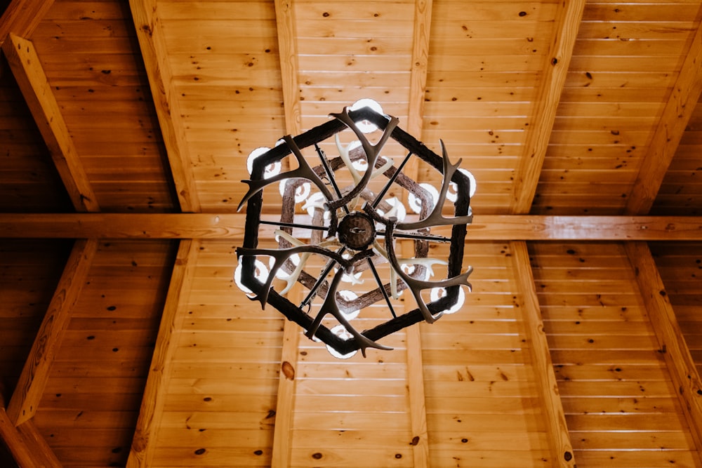 a chandelier hanging from a wooden ceiling