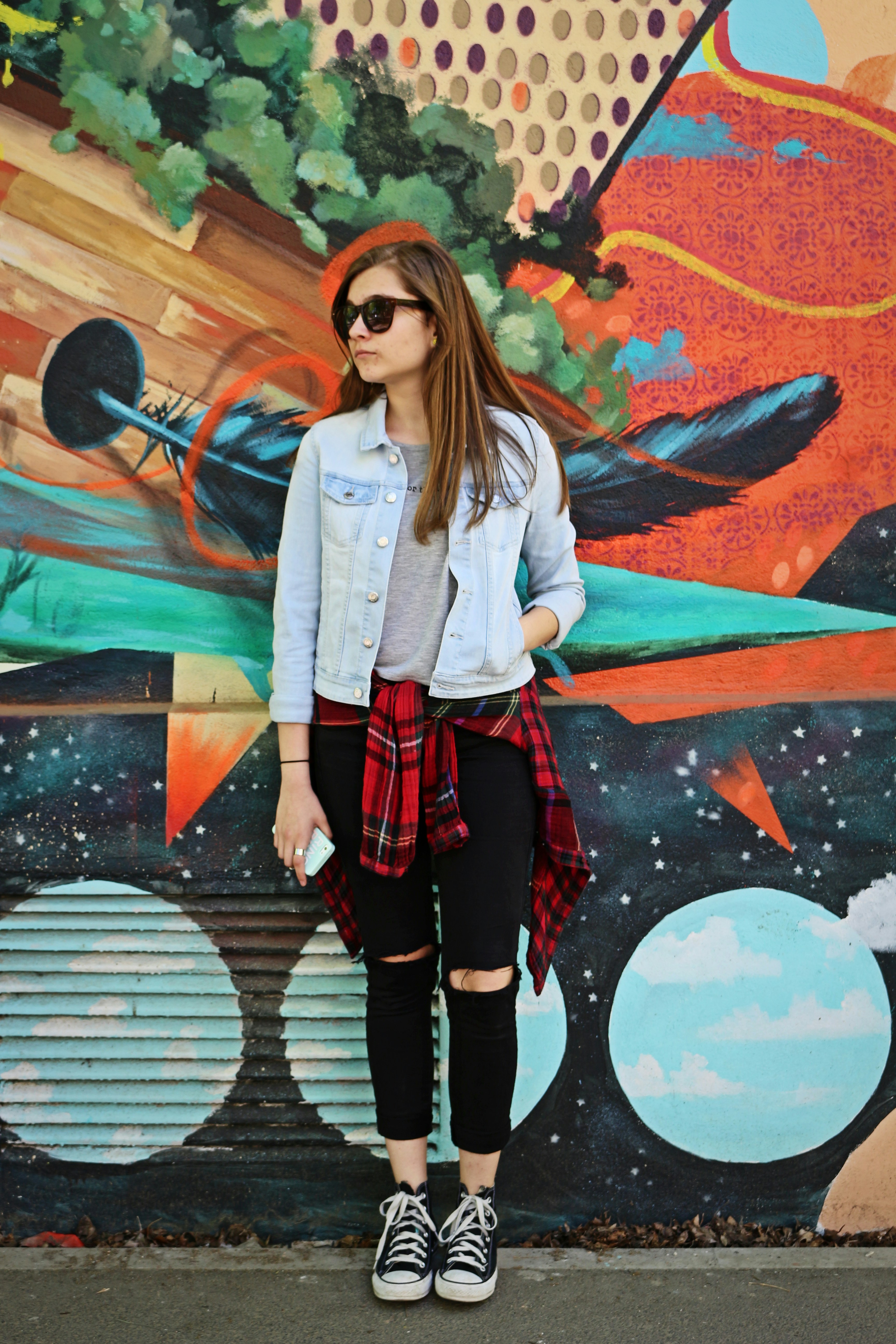 A woman standing in front of a colorful wall photo – Free Apparel Image ...