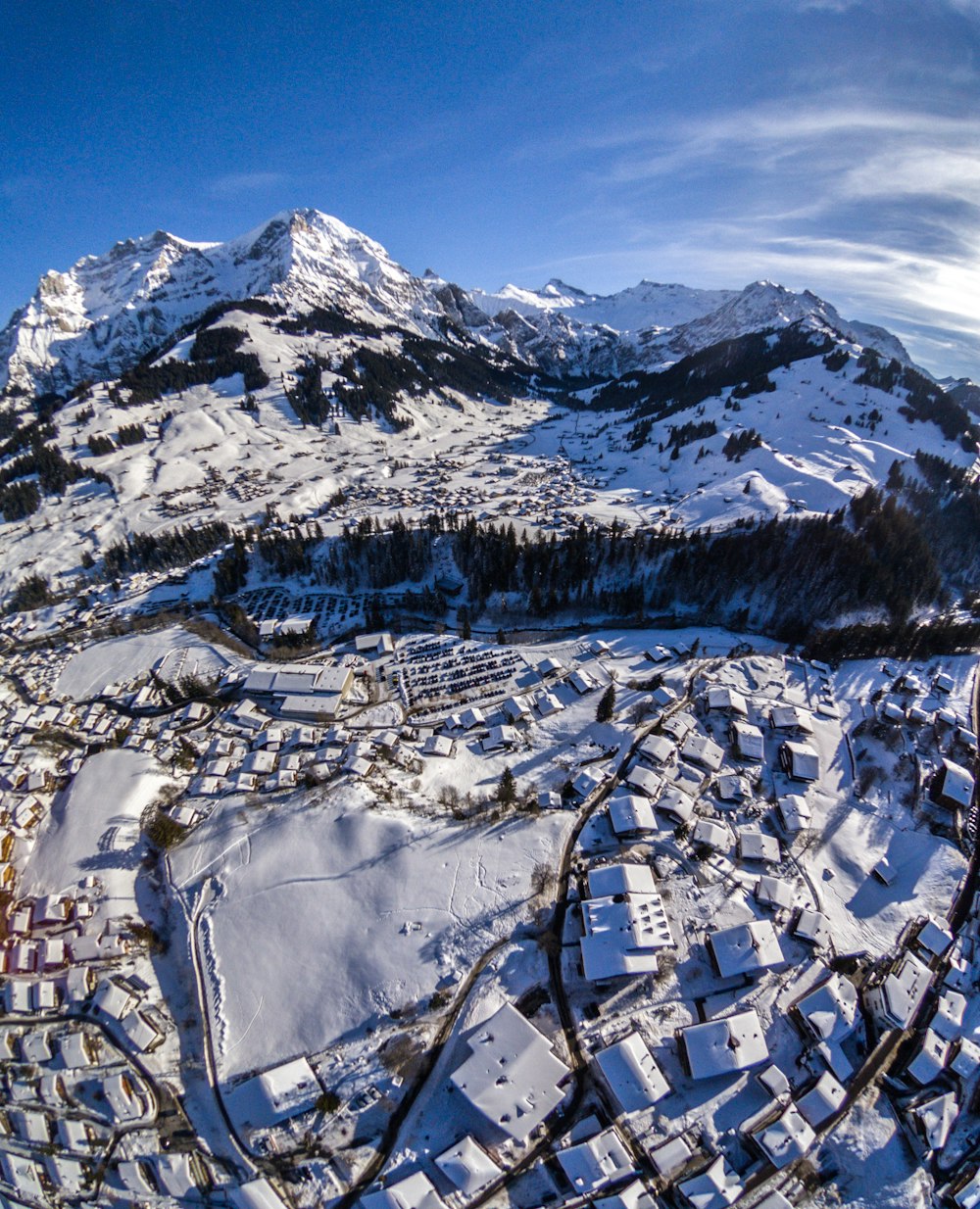 snow capped village near mountain during daytime