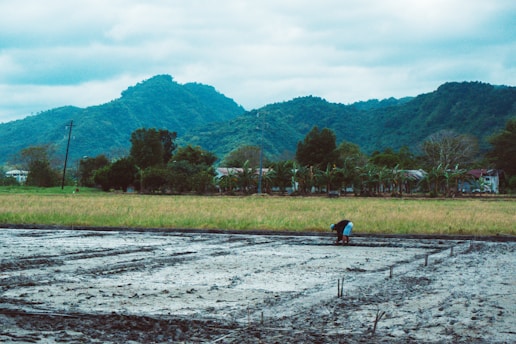 A field researcher interviewing locals in a rugged, unstable environment.