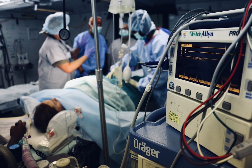 group of people doing a surgery on a person inside the operating room