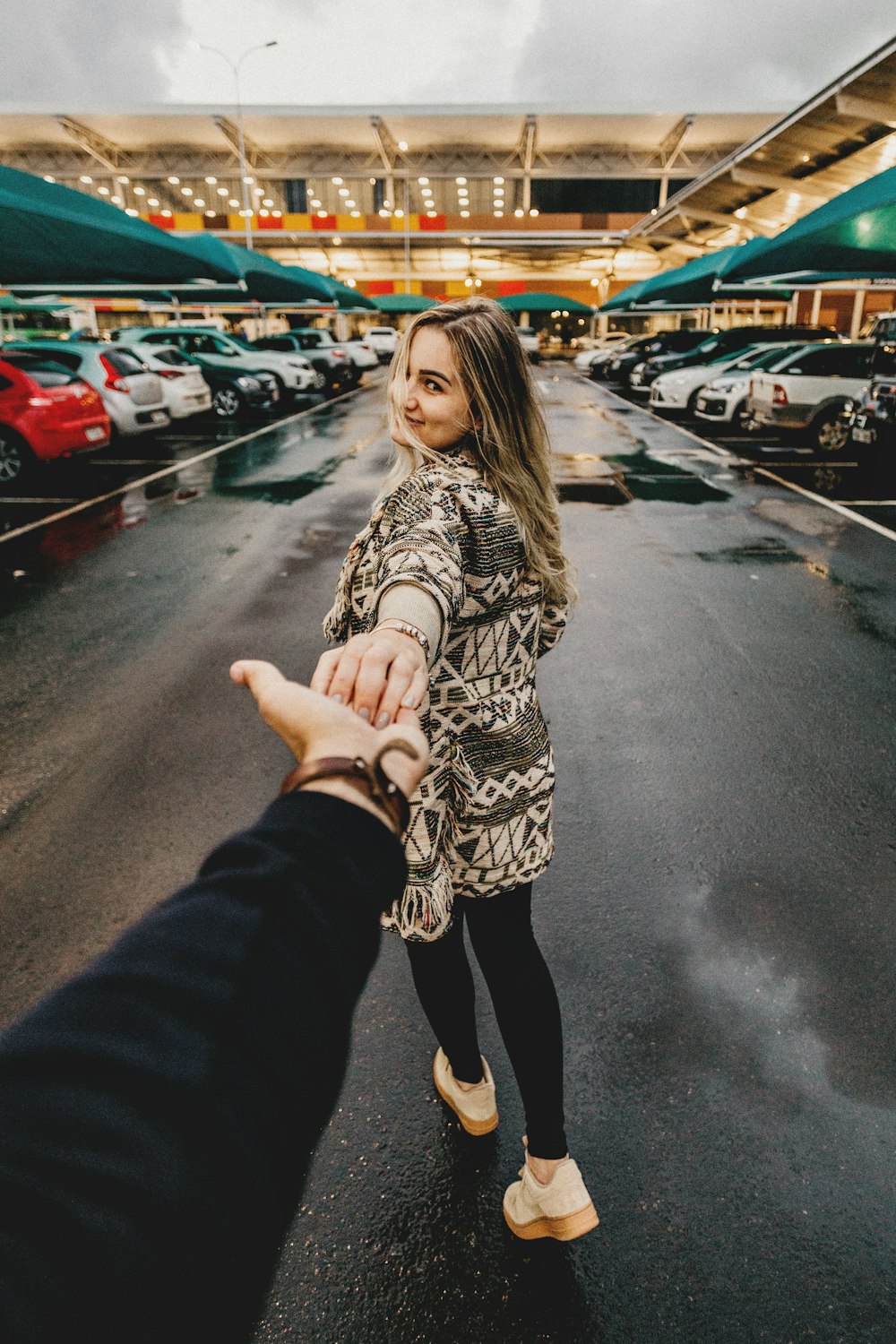 man and woman walking near parking lot take me there photography