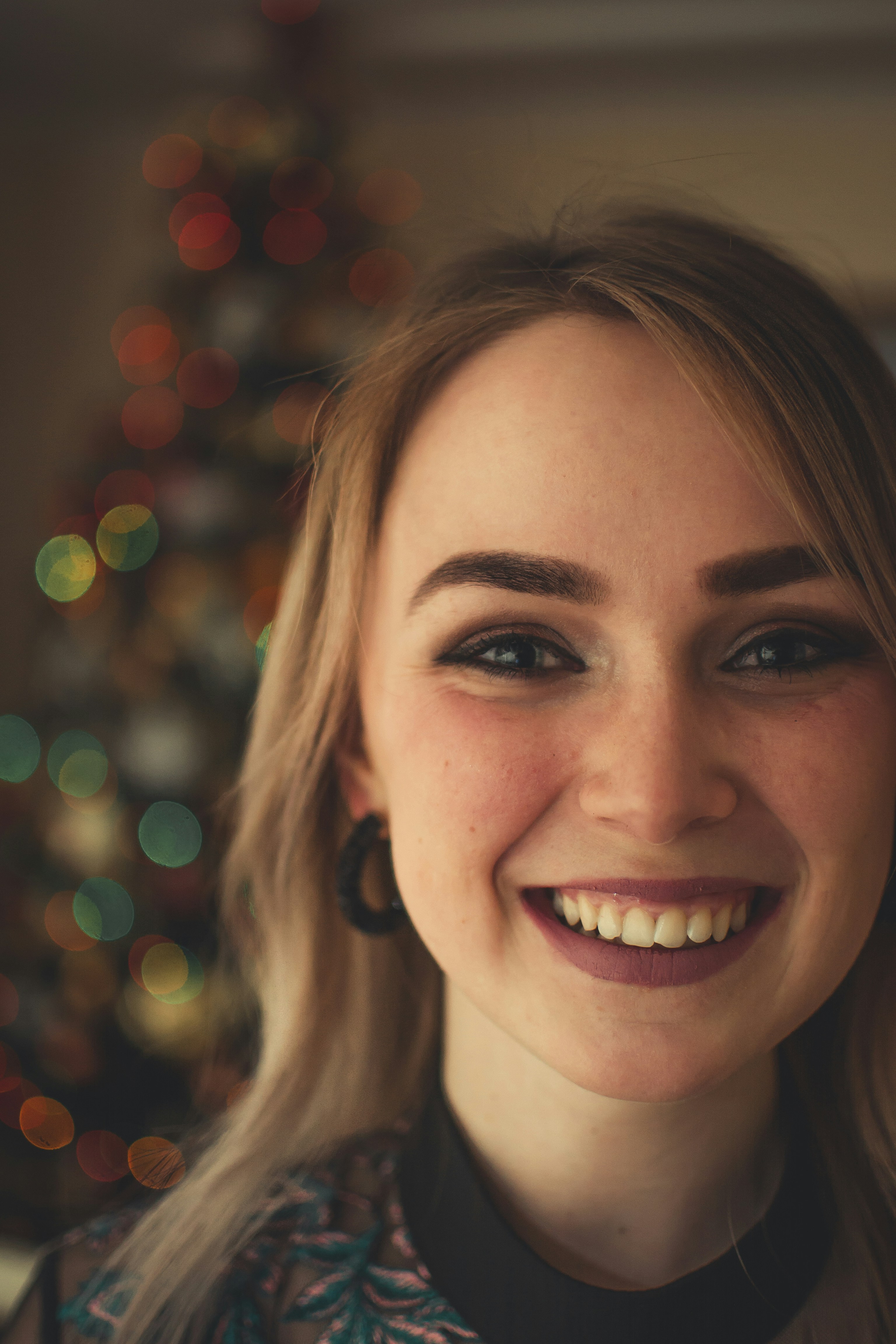 Close-up of a smiling woman with a violet background, symbolizing digital success.
