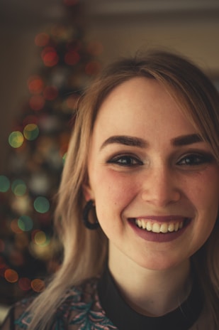 Photographer capturing a joyful woman with professional lighting setup.