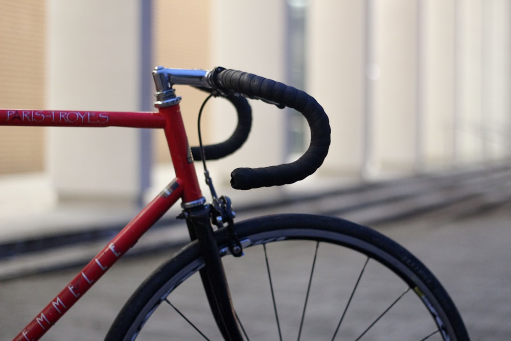 selective focus photography of red and black bicycle