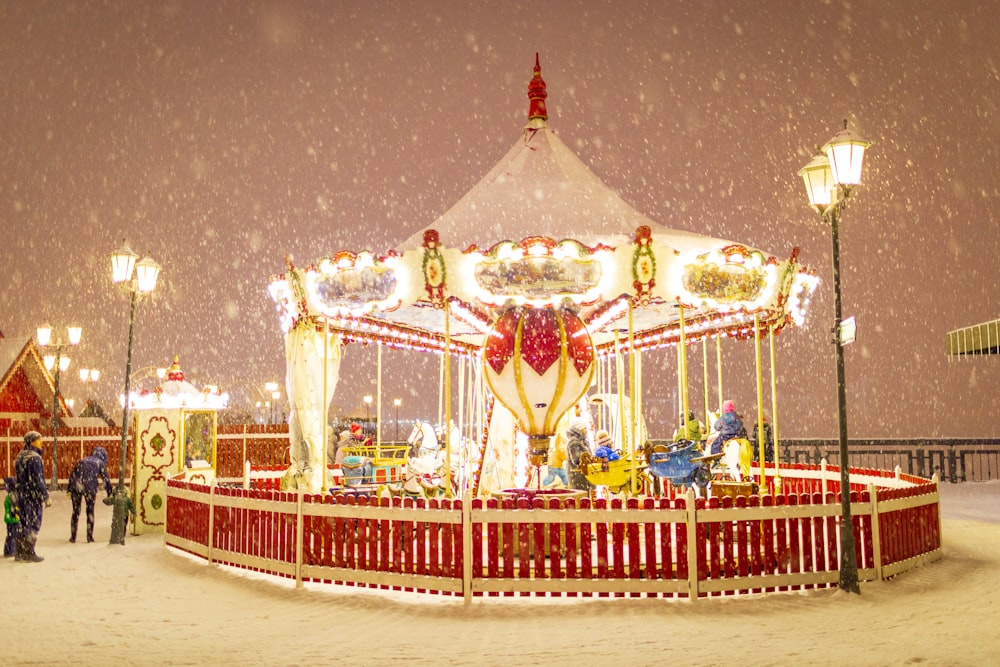 red and white carousel during snowy night