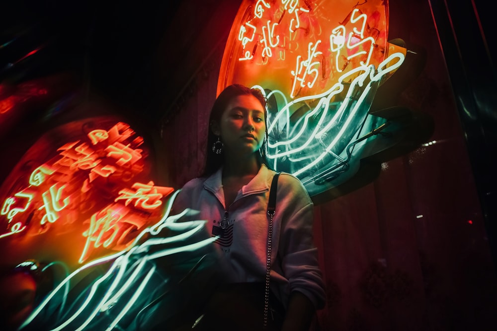 woman standing beside LED signage