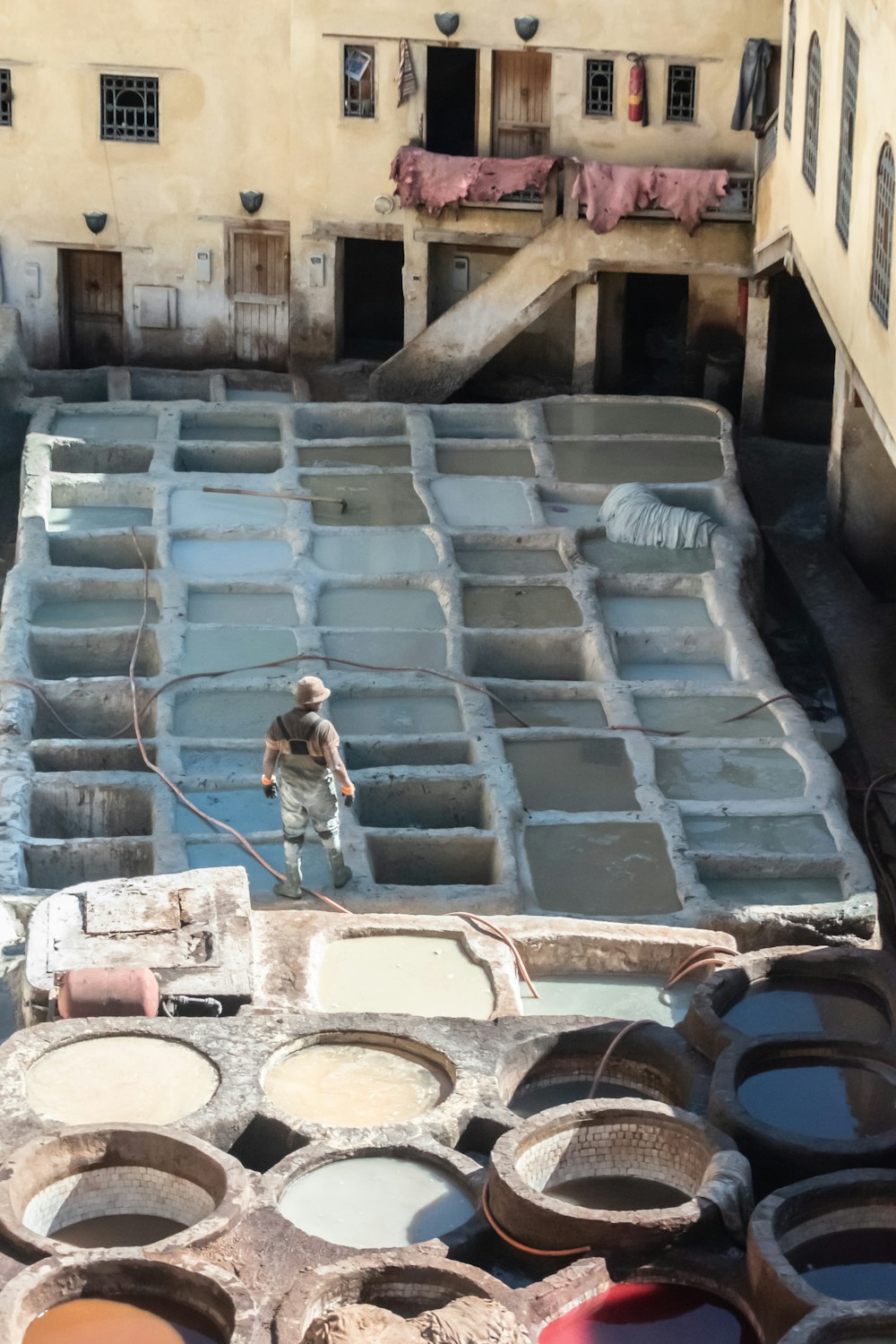 man standing near brown concrete building