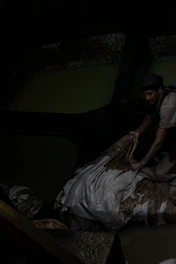 Skilled technician inspecting rexine texture under bright factory lights.