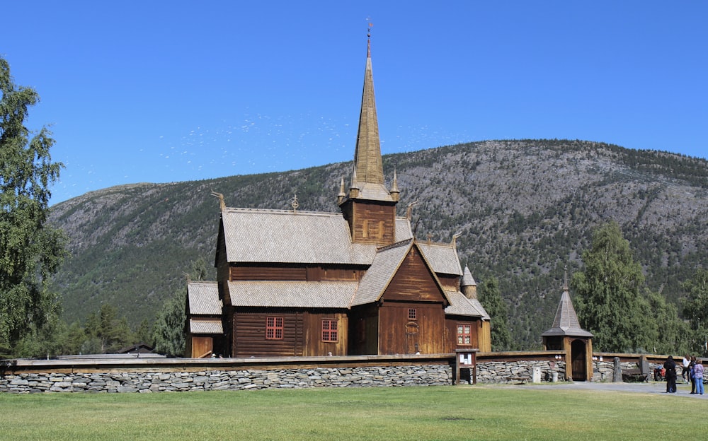 brown wooden house near mountain