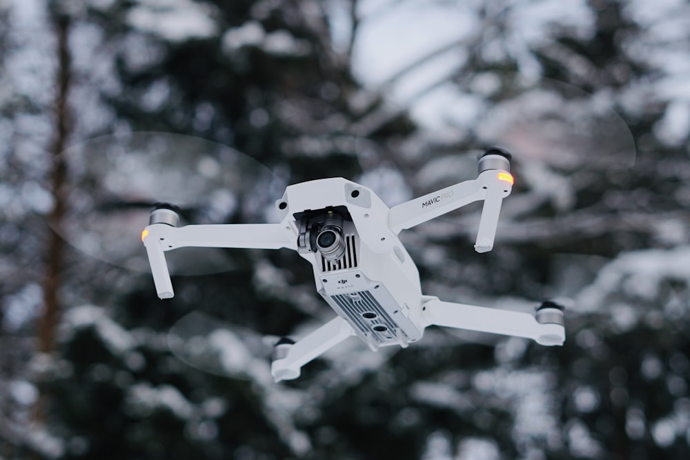 selective focus photography of white drone quadcopter