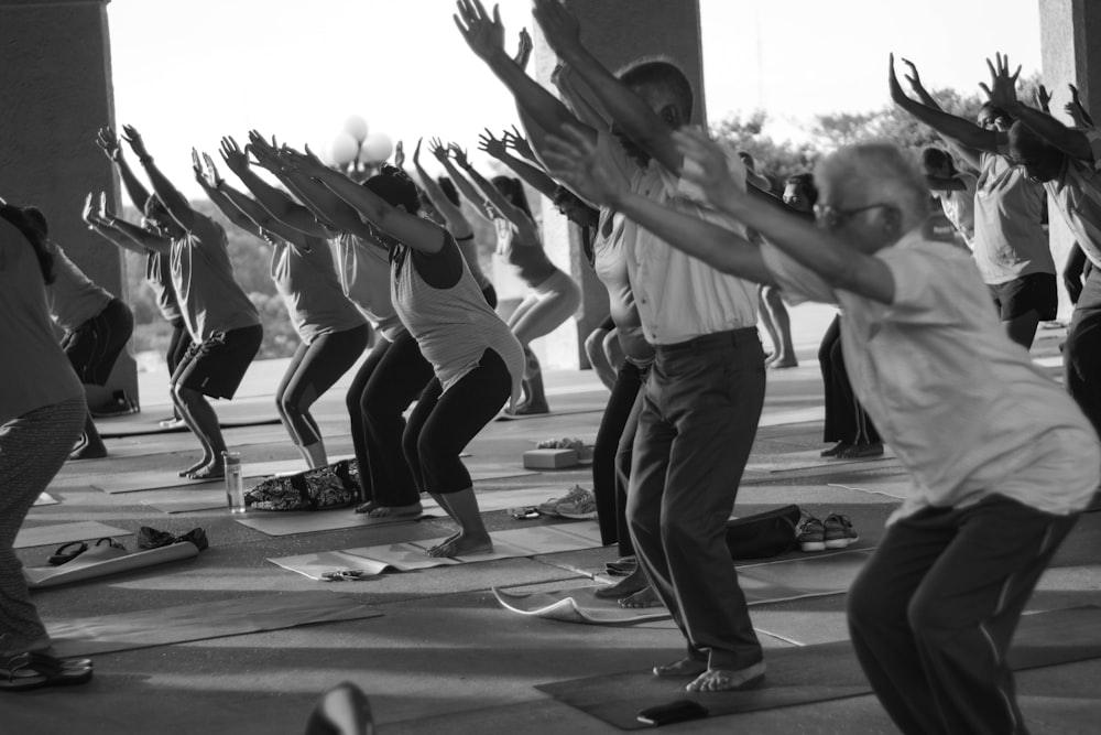 grayscale photo of people exercising