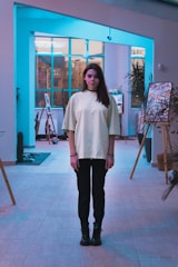 Portrait of Anees Rahman in a minimalist studio setting with architectural sketches in the background.