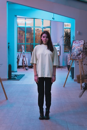 Portrait of Anees Rahman in a minimalist studio setting with architectural sketches in the background.