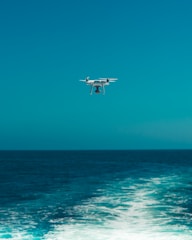 Nautical drone swarm flying over ocean waves, monitoring marine conditions.