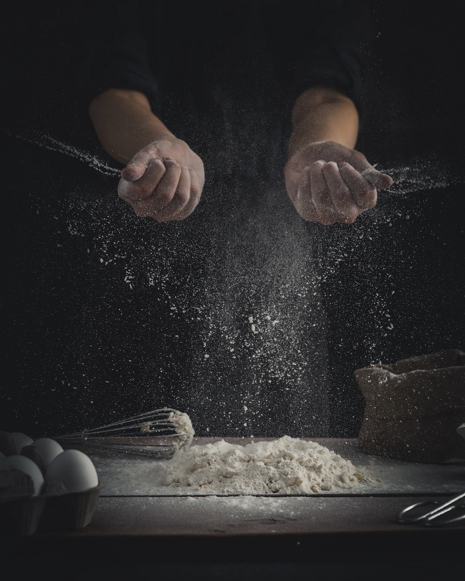 Flour-dusted hands working fresh noodle dough in warm, directional light — placeholder for commissioned hero photography