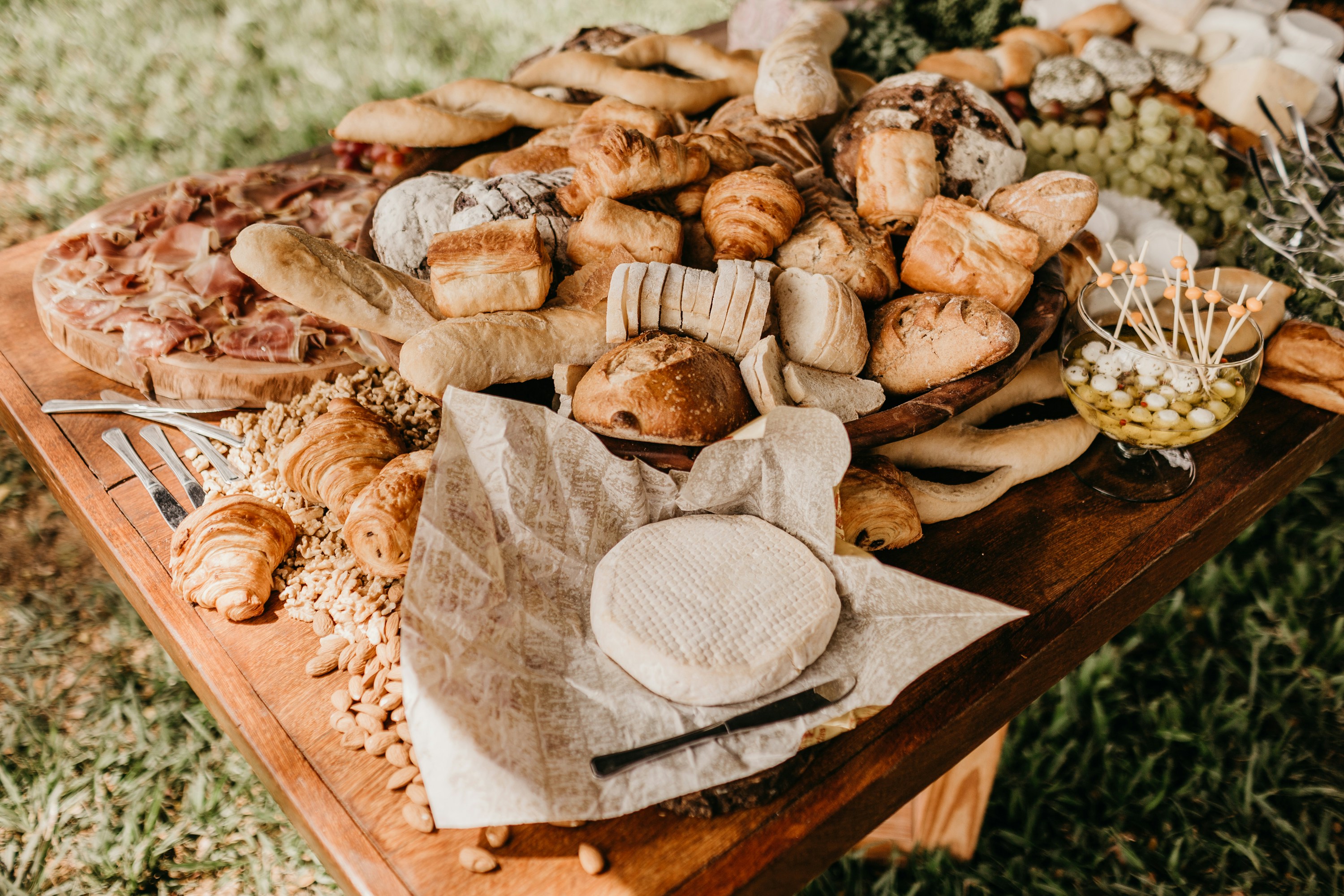 bread on brown wooden table outdoors, 