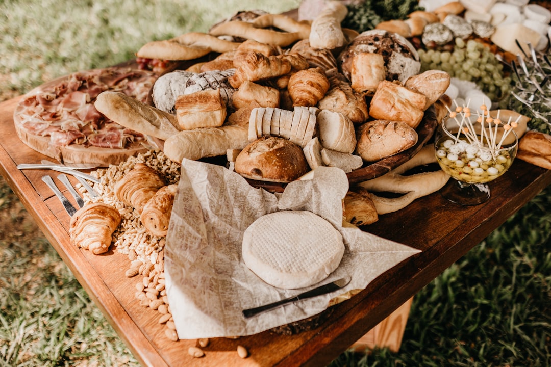bread on brown wooden table outdoors,