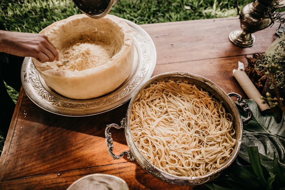 pasta in cooking pot on brown wooden table