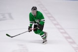 hockey player wearing full gear on ice skating field