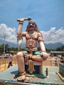 brown and grey man and cobra statue at the park
