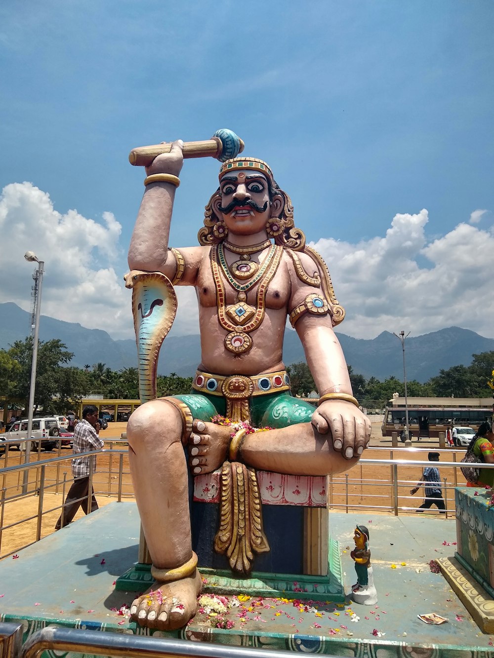 brown and grey man and cobra statue at the park