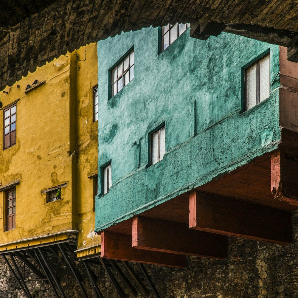 yellow and green painted buildings at daytime