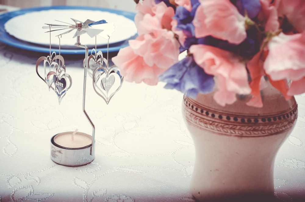 heart-shaped clear glass table decor beside vase
