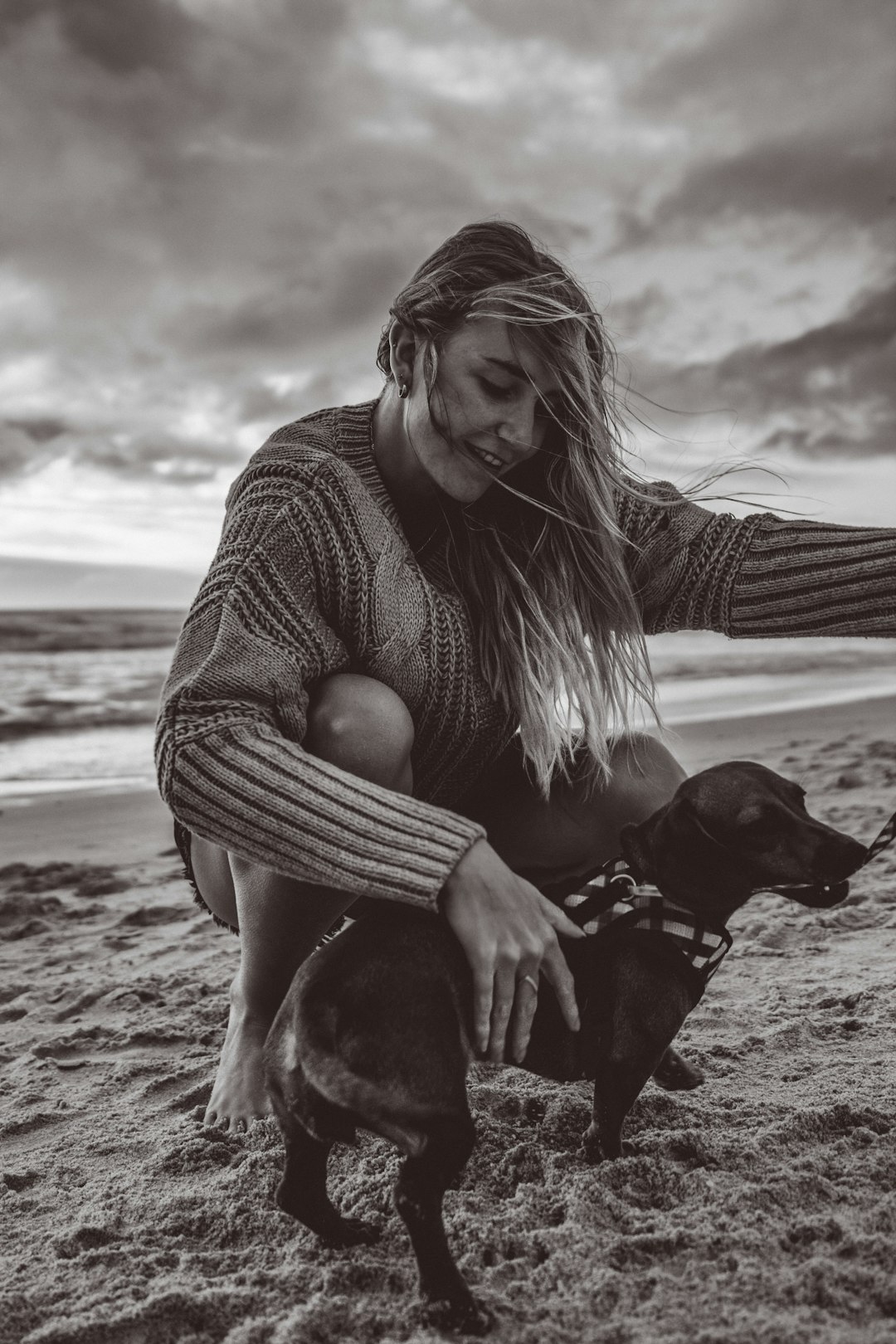 grayscale photo of woman holding puppy