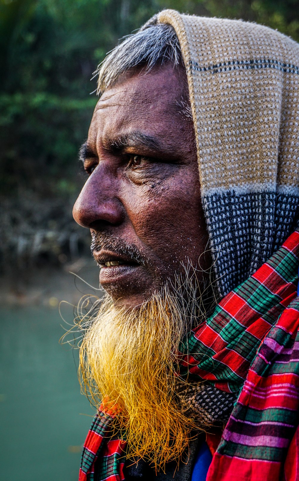 man wearing red,green,and purple plaid scarf