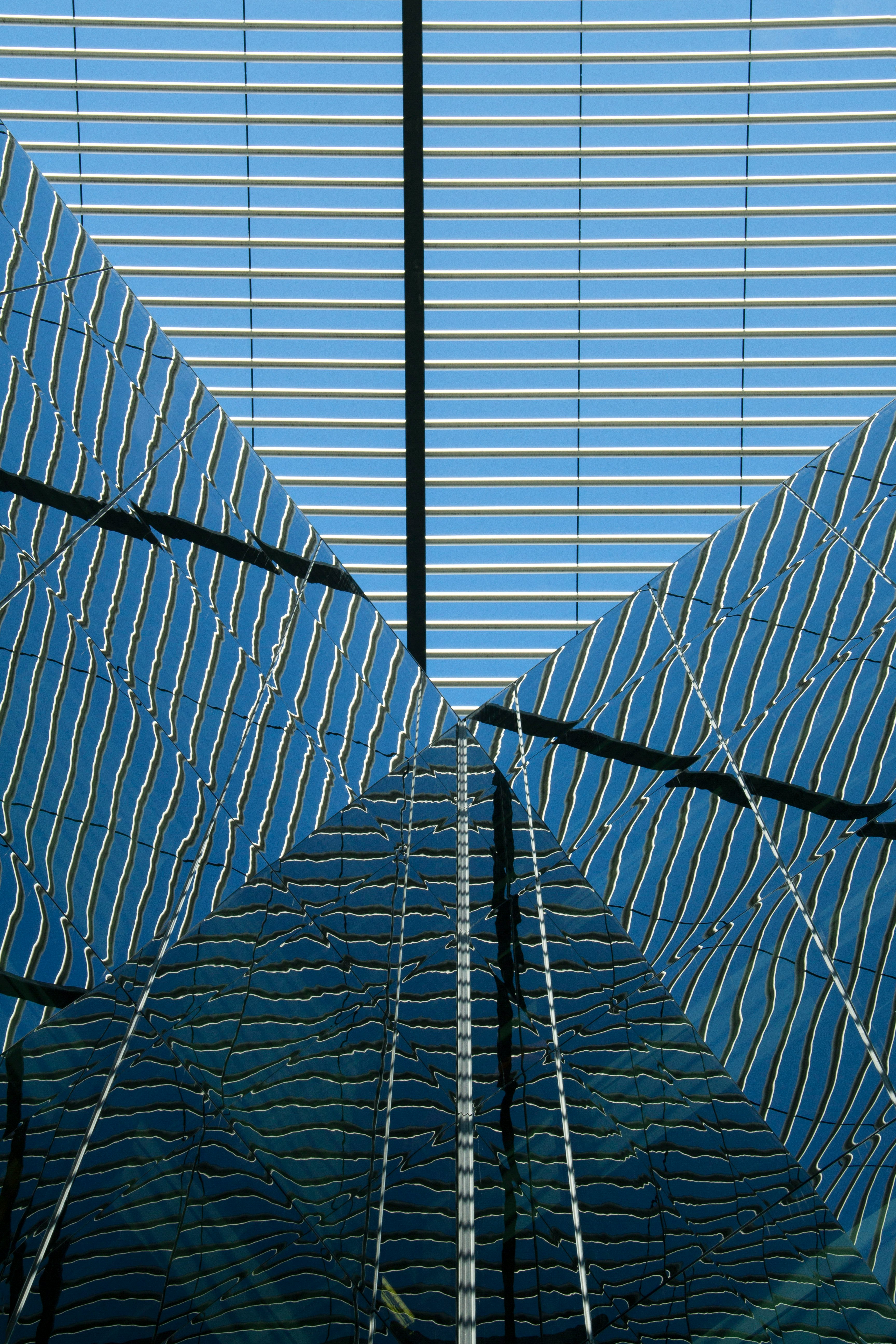 blue and white glass building close-up photography