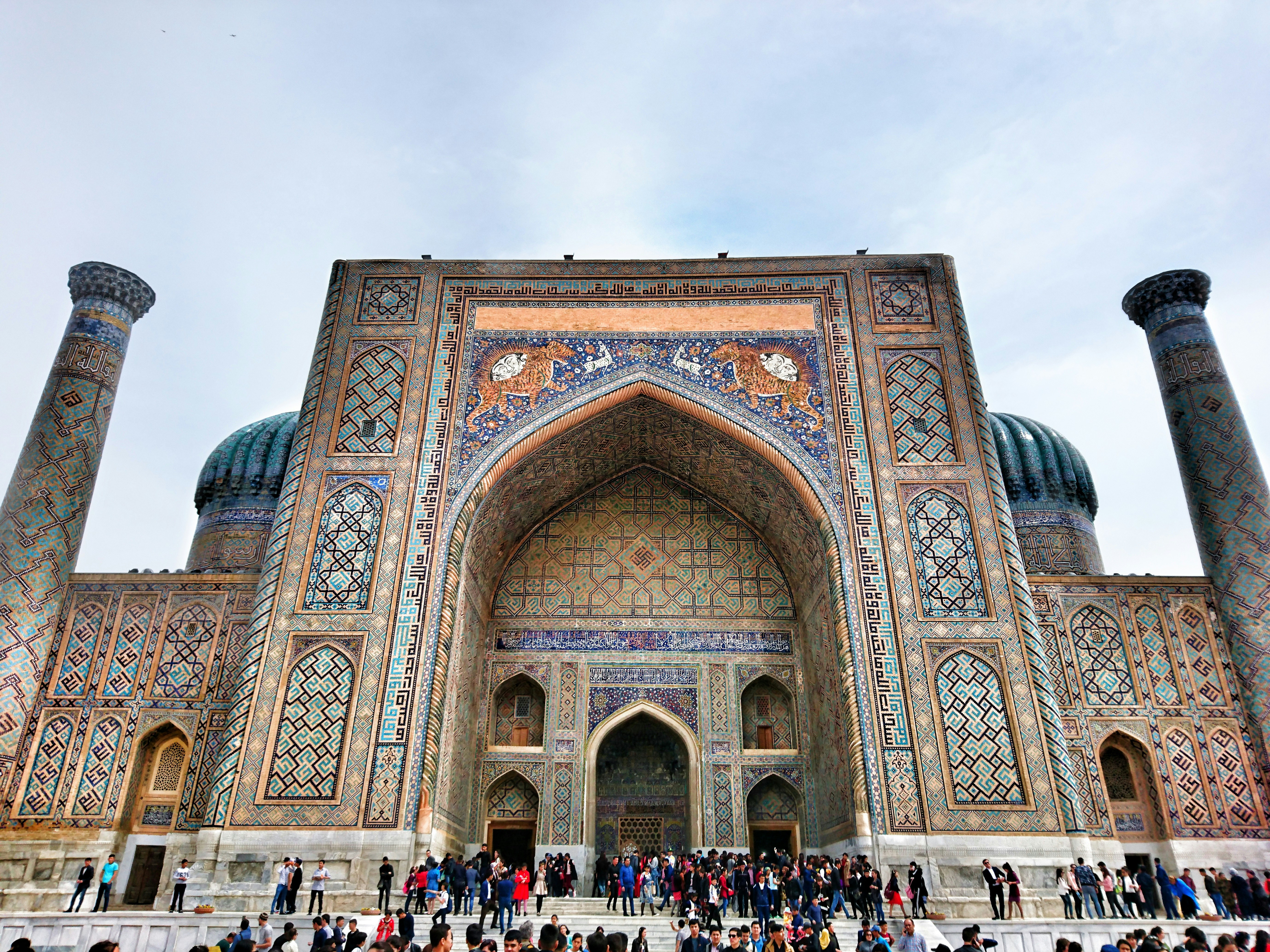 people standing outside mosque during daytime