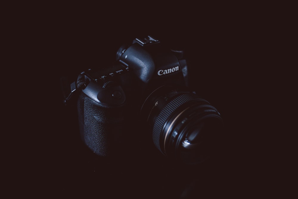 black Canon DSLR camera with black background