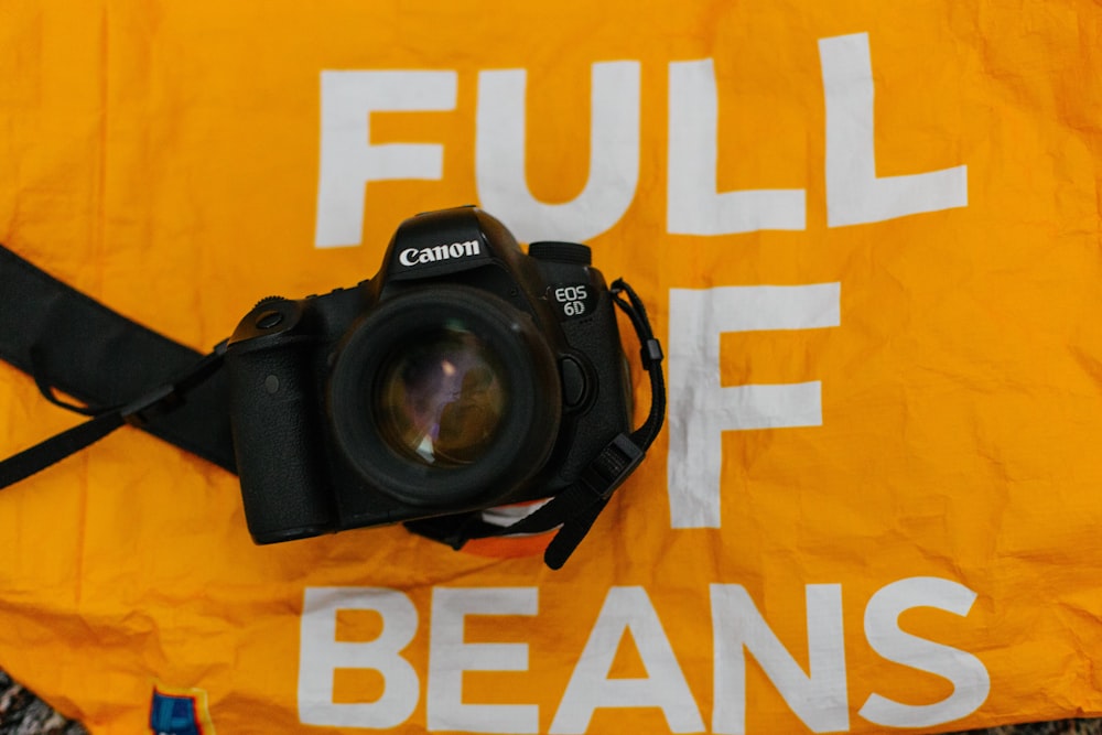 a camera sitting on top of a yellow banner