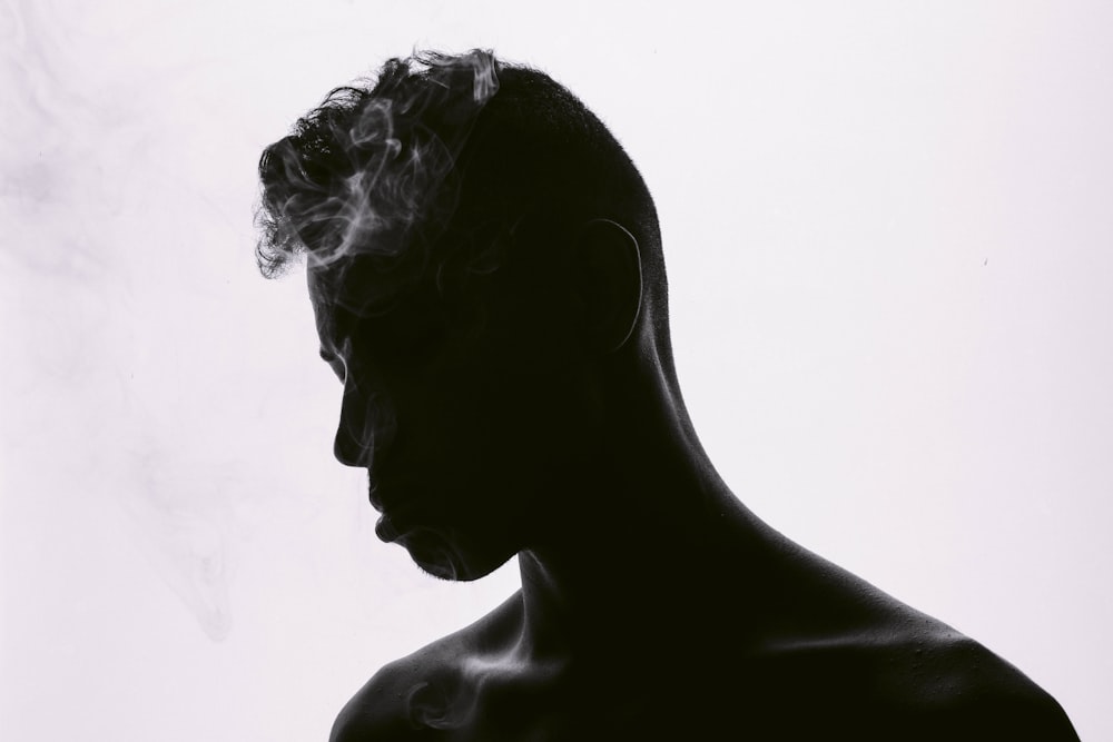 silhouette of man smoking