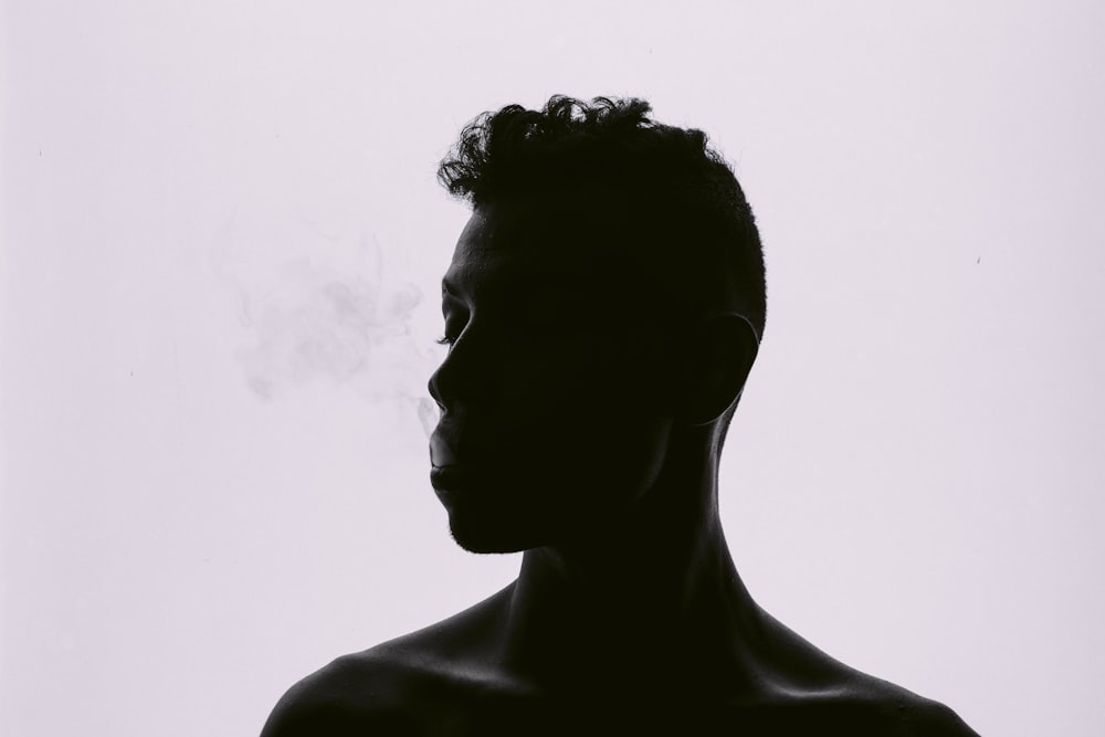 silhouette of man smoking
