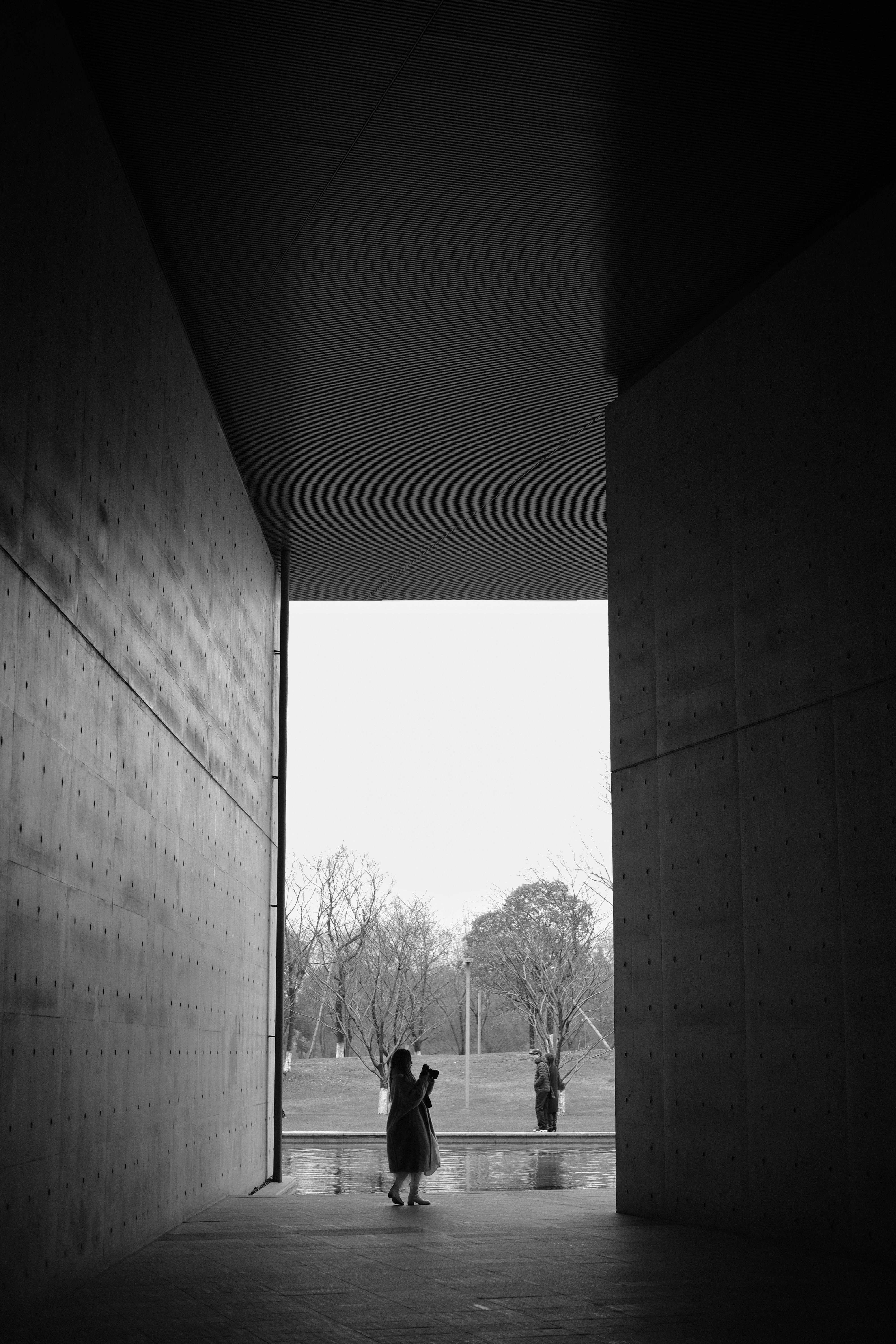 Person standing in between building photo Free White Image on Unsplash