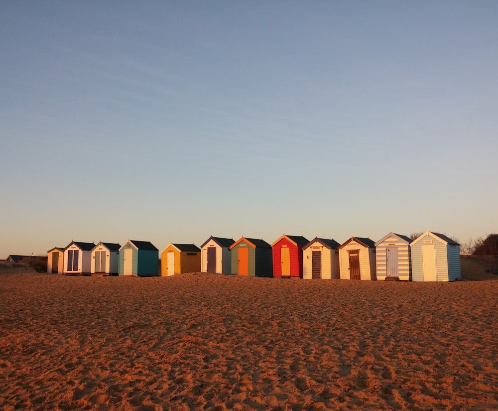 wooden sheds on desert during daytime