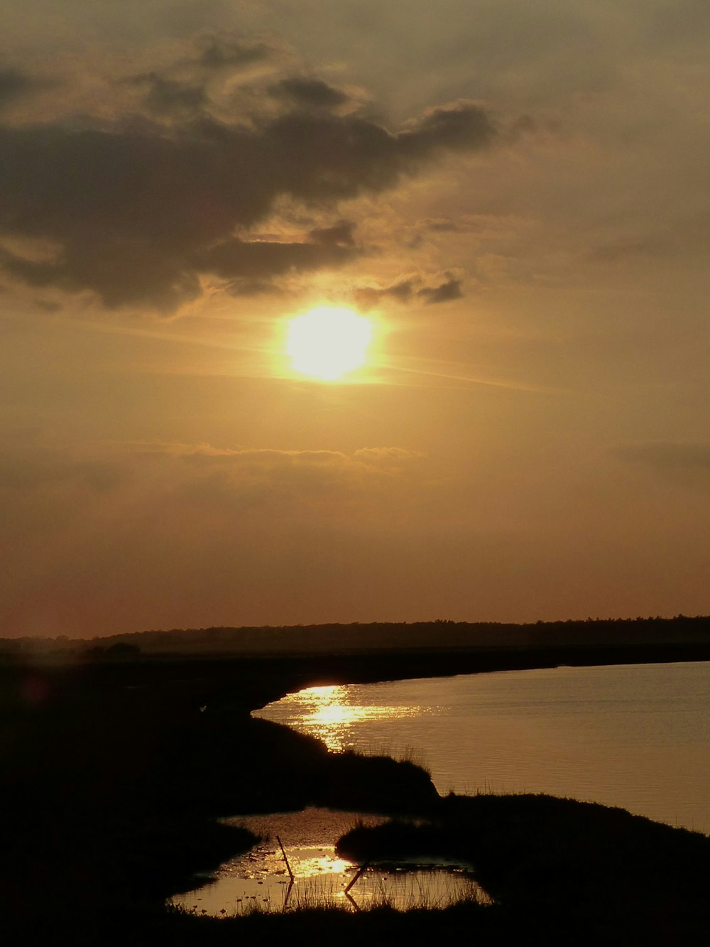 land mass and body of water during golden hour