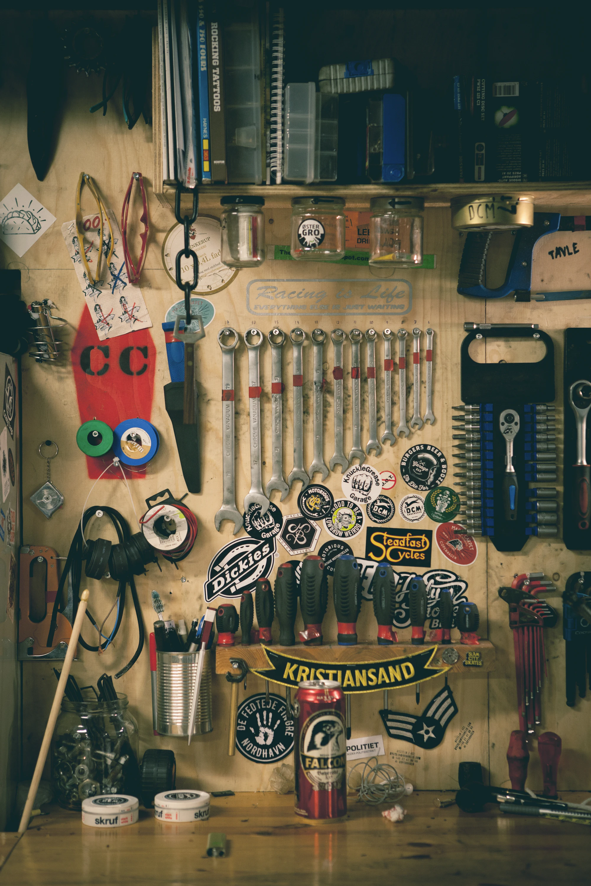 A workshop wall hung with spanners, sockets and hand tools