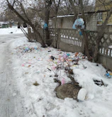 Urban area showing the contrast between clean streets and nearby waste accumulation.