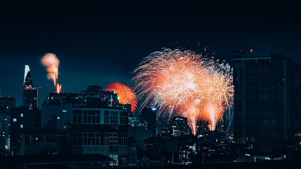 fireworks are lit up in the night sky above a city