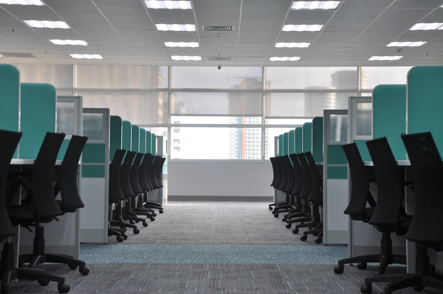 Commercial workspace interior with rows of workstations and natural light
