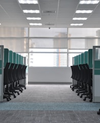 empty black rolling chairs at cubicles