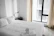 A smiling guest leaving a sparkling clean short-term rental with fresh linens and bright windows.