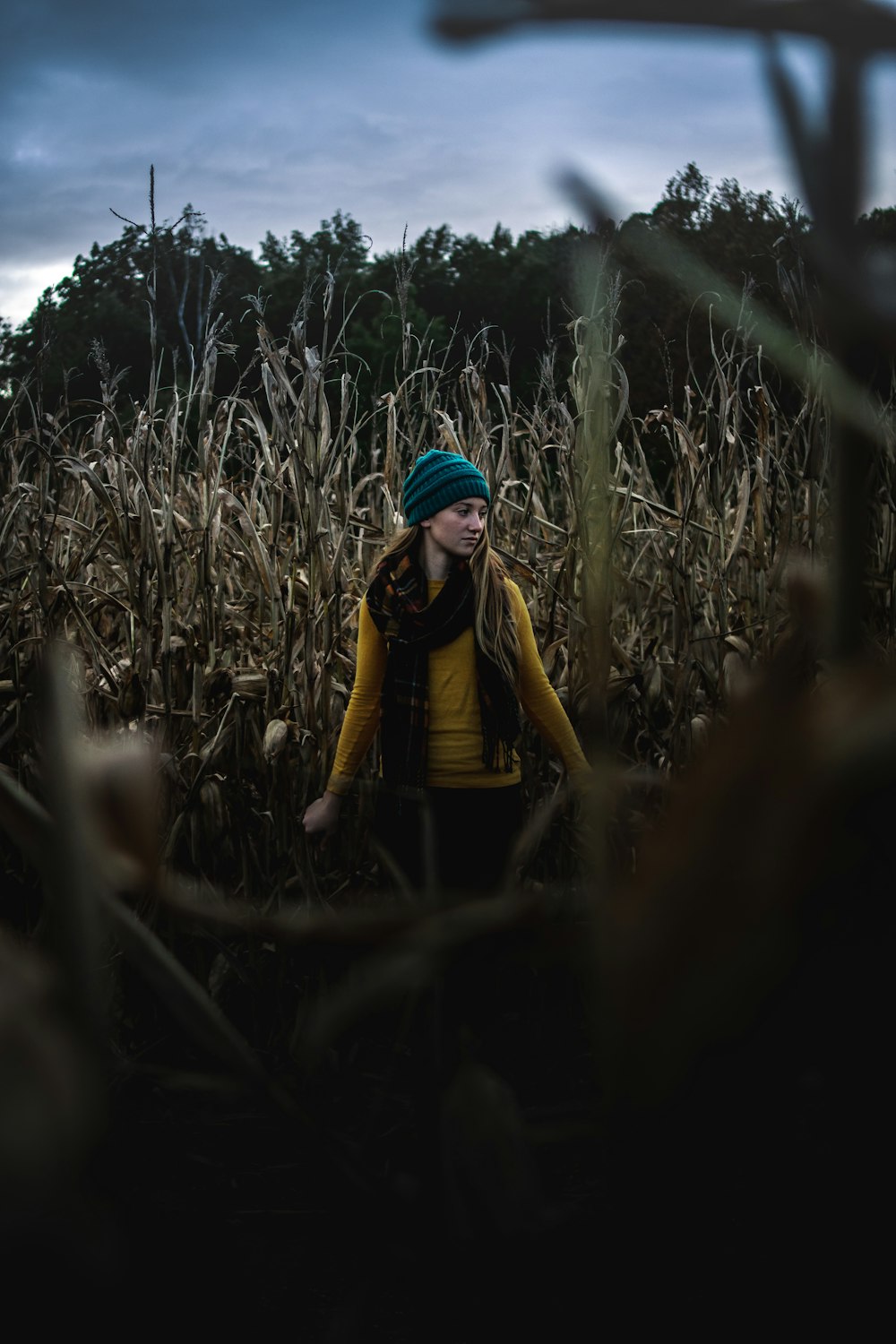 selective focus photography of woman standing on grass field