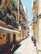 empty seats and tables in between buildings during daytime