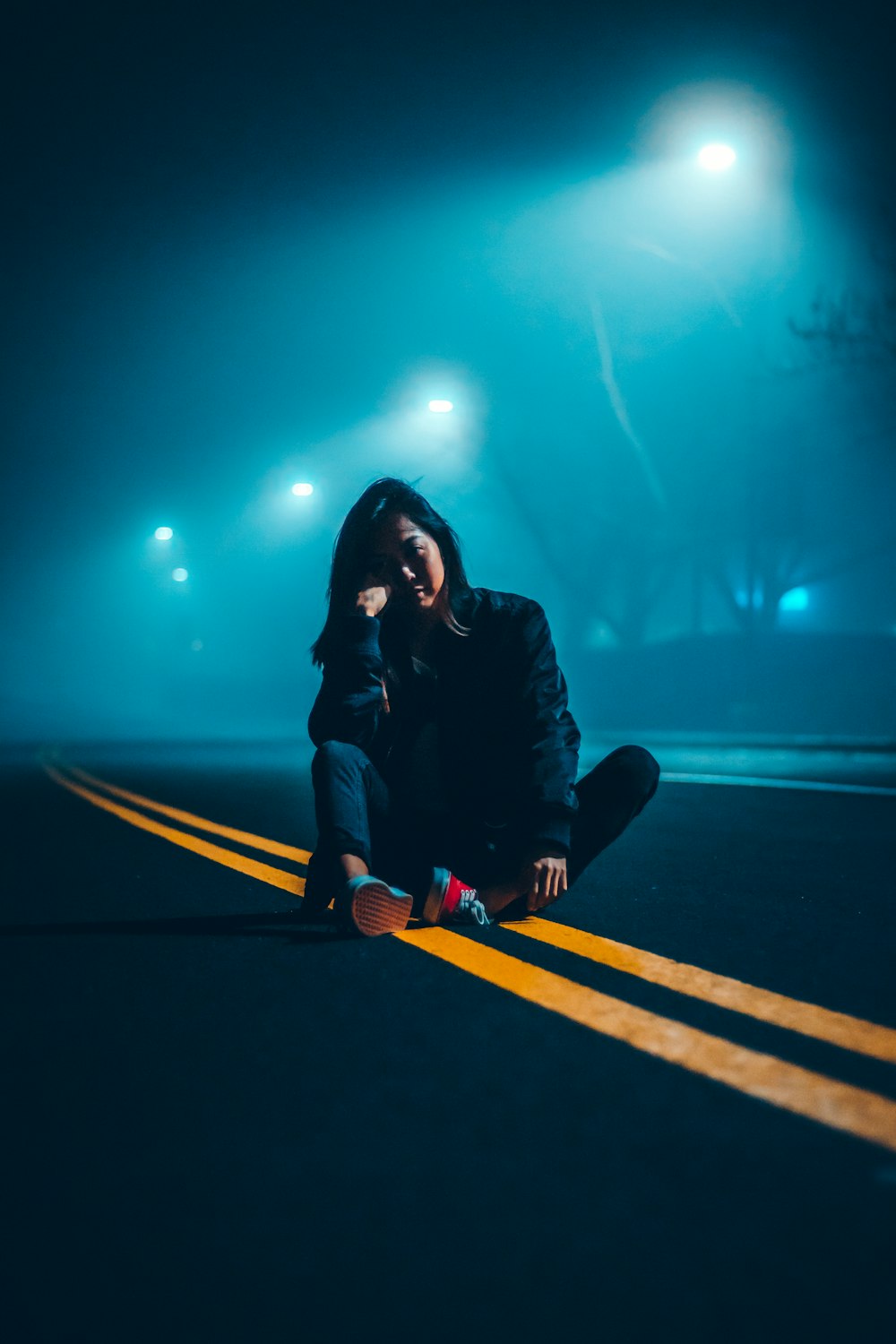 woman sitting on road