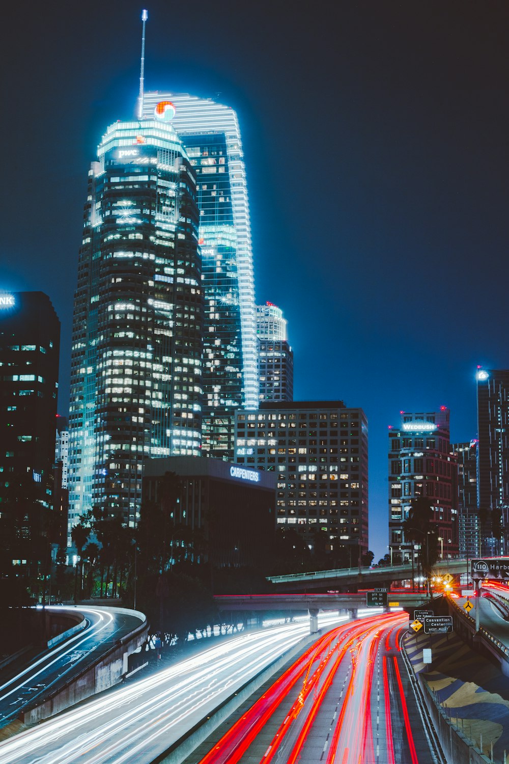 time lapsed photography of vehicles beside buildings